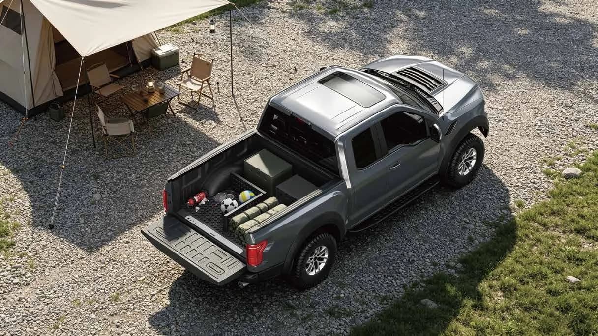 Pickup with organized cargo beside a campsite