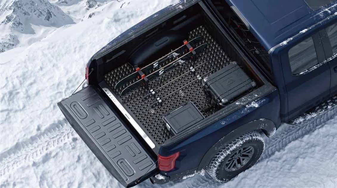 Pickup bed carrying gear in a snowy outdoor setting