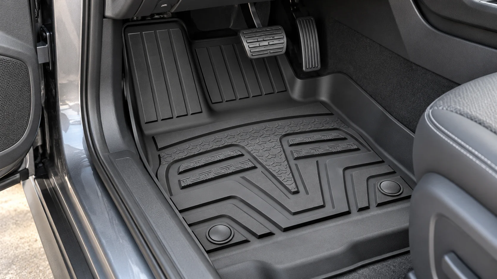 Editorial visualization of a molded TPE floor mat in a car footwell
