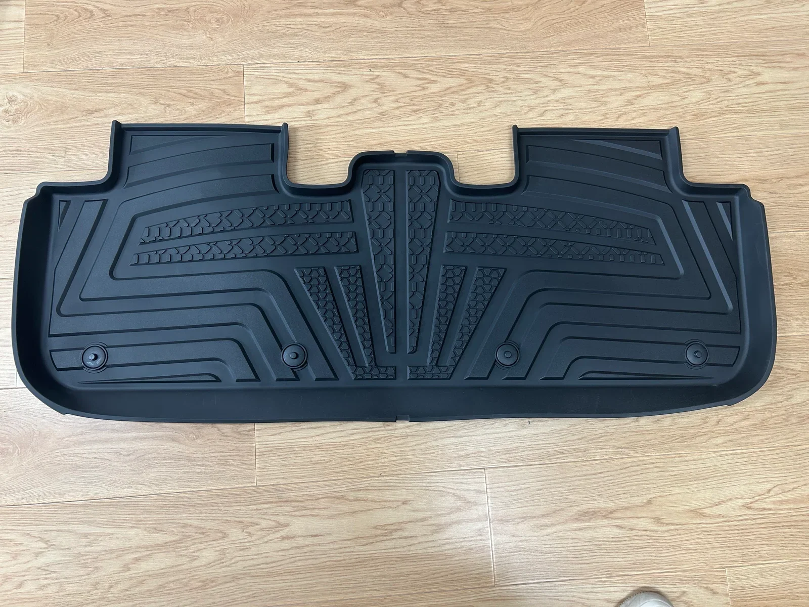 Provided photo of a black molded rear floor mat